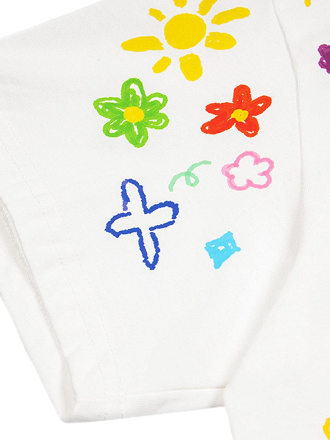 Colorful hand-painted details on a white T-shirt by TALISHKO, featuring playful retro designs.