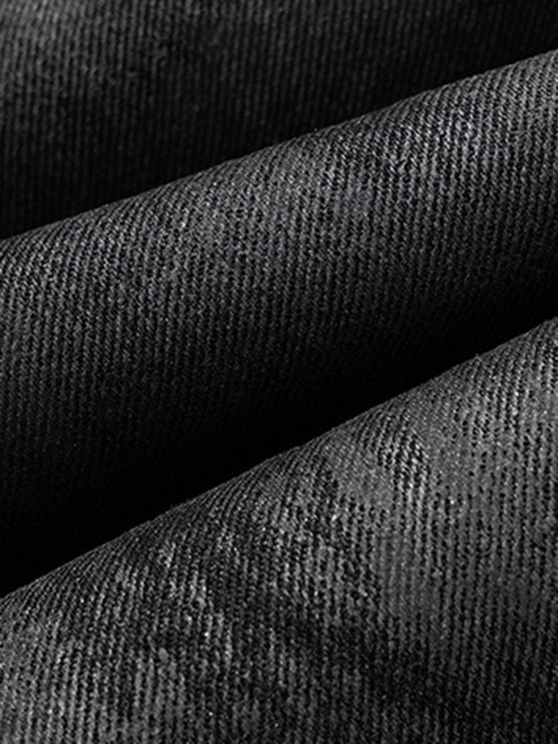 Zoomed-in texture of TALISHKO retro hand-brushed glitter flare jeans highlighting the fabric detail.