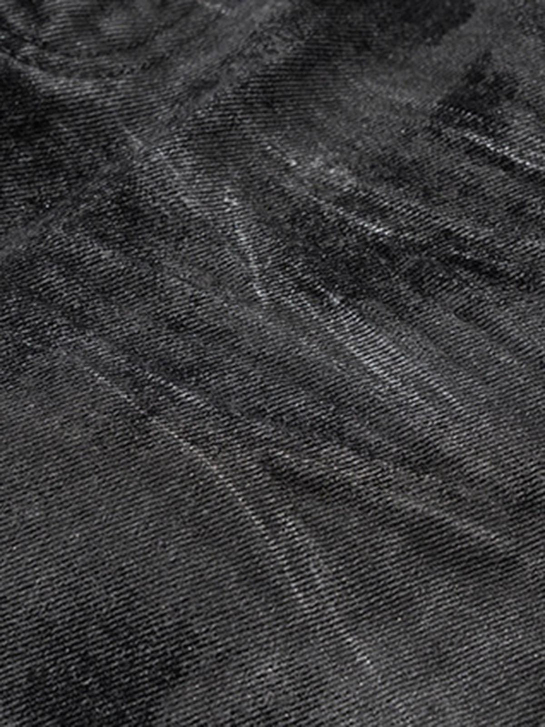 Texture and pattern showcased on TALISHKO's retro hand-brushed glitter flare jeans.