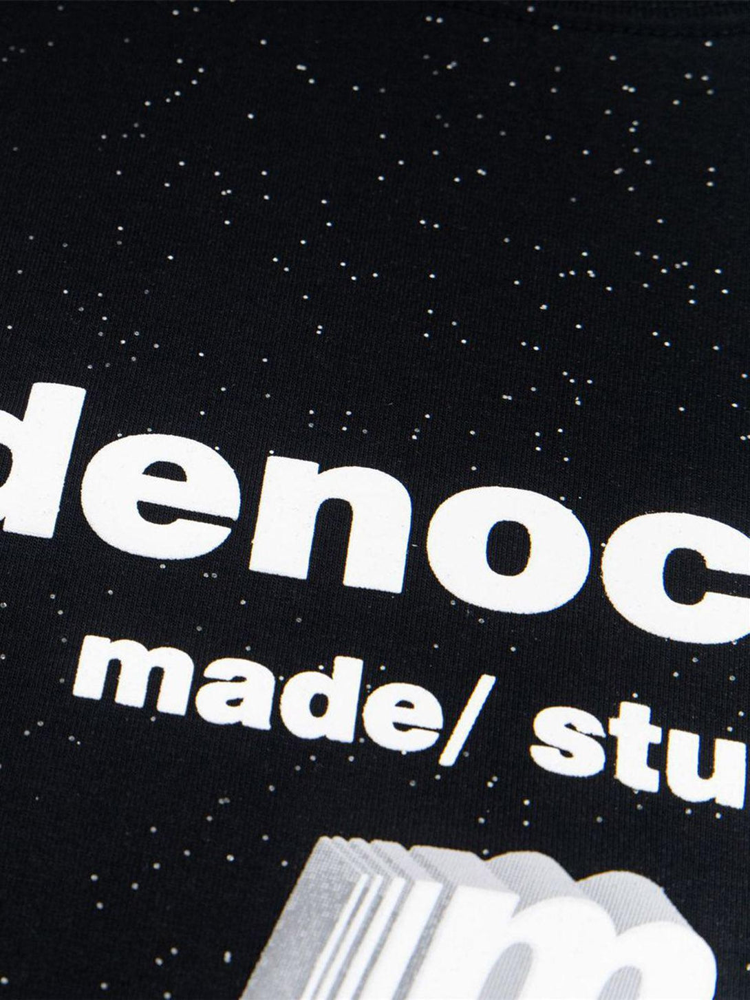 Intricate look at TALISHKO's bold font and starry pattern on a black short-sleeved tee.