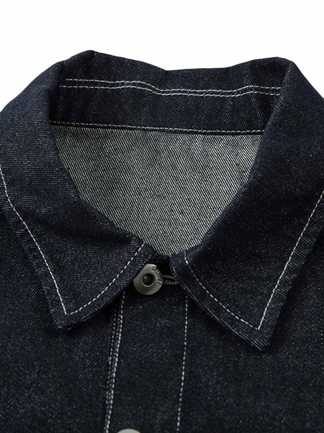 A detailed view of TALISHKO's contrast color denim jacket collar, highlighting retro stitching.