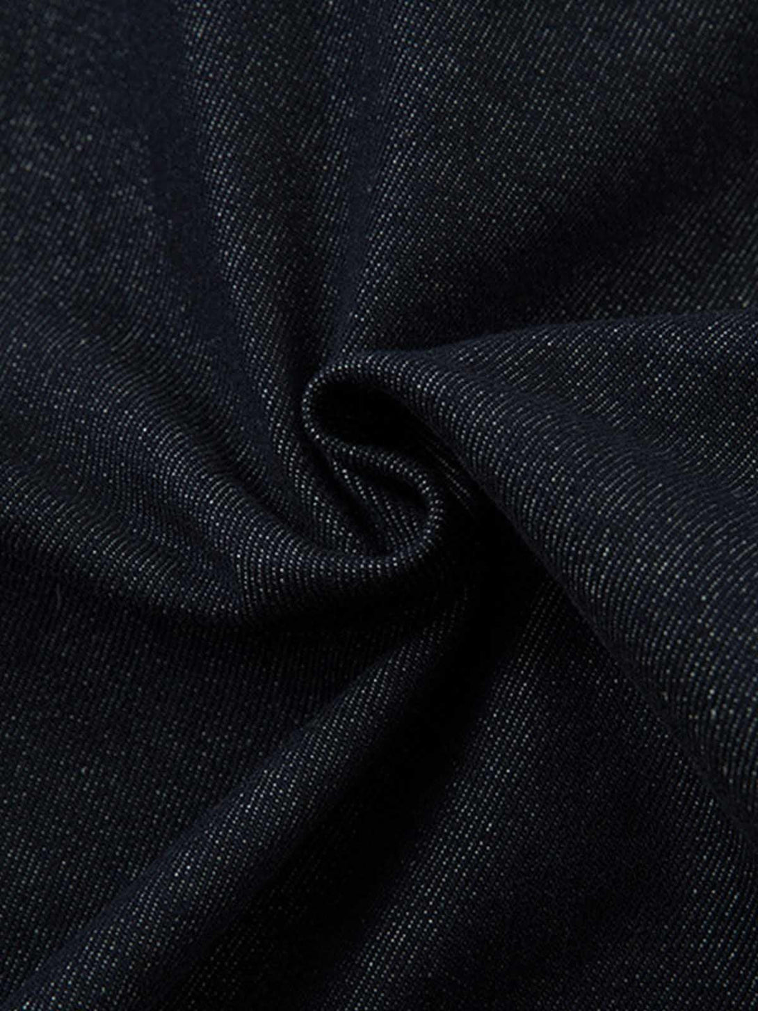 Zoomed-in texture of TALISHKO's retro denim fabric, highlighting the heavy washed finish.