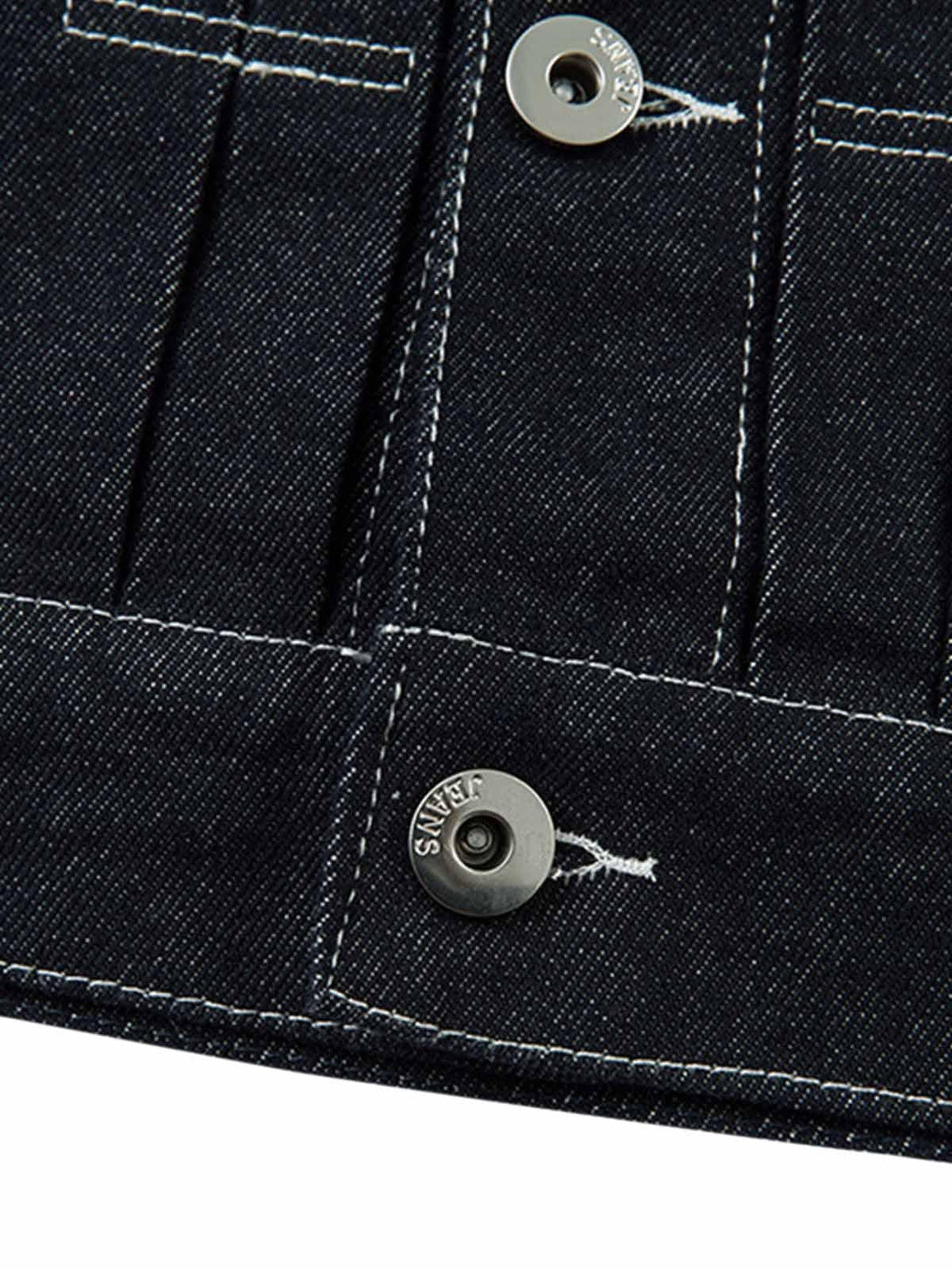 Intricate look at TALISHKO's denim jacket buttons, showcasing retro stitching details.