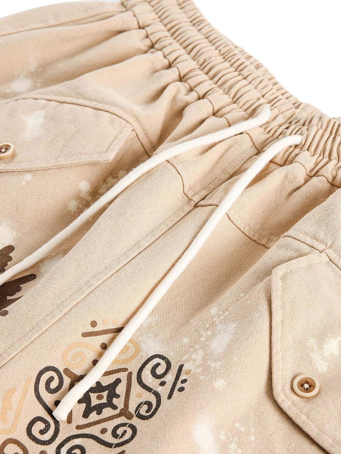 A detailed view of TALISHKO hip-hop shorts, showcasing unique hieroglyphic patterns and drawstring waist.