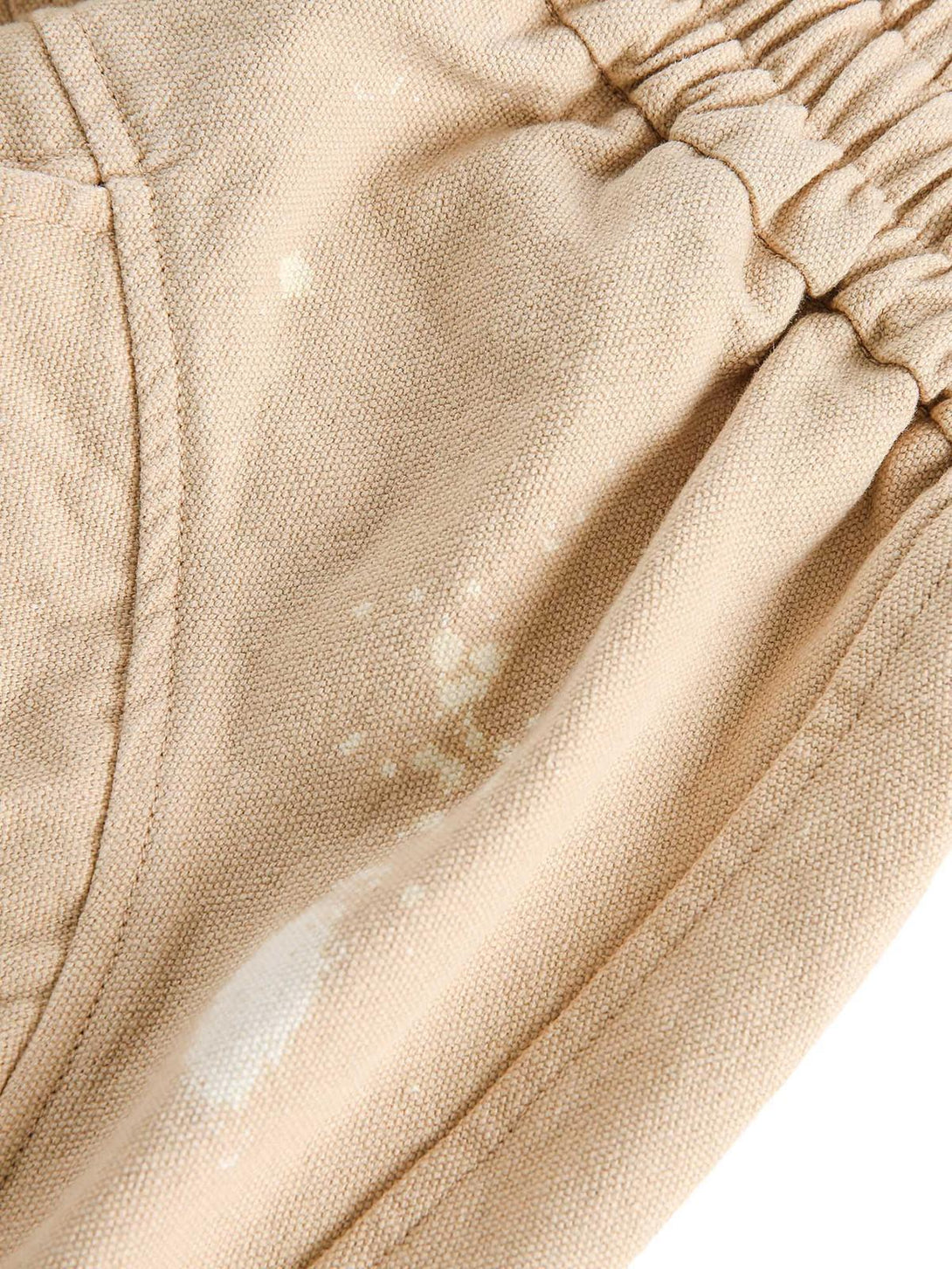 Zoomed-in texture of TALISHKO hip-hop shorts, highlighting retro patterns and gathered waist.