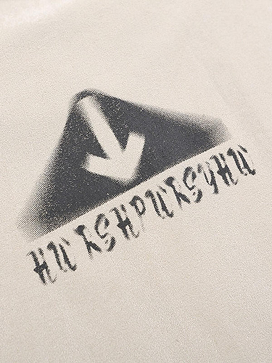 Zoomed-in view of abstract print on beige vest by TALISHKO, highlighting unique retro style.