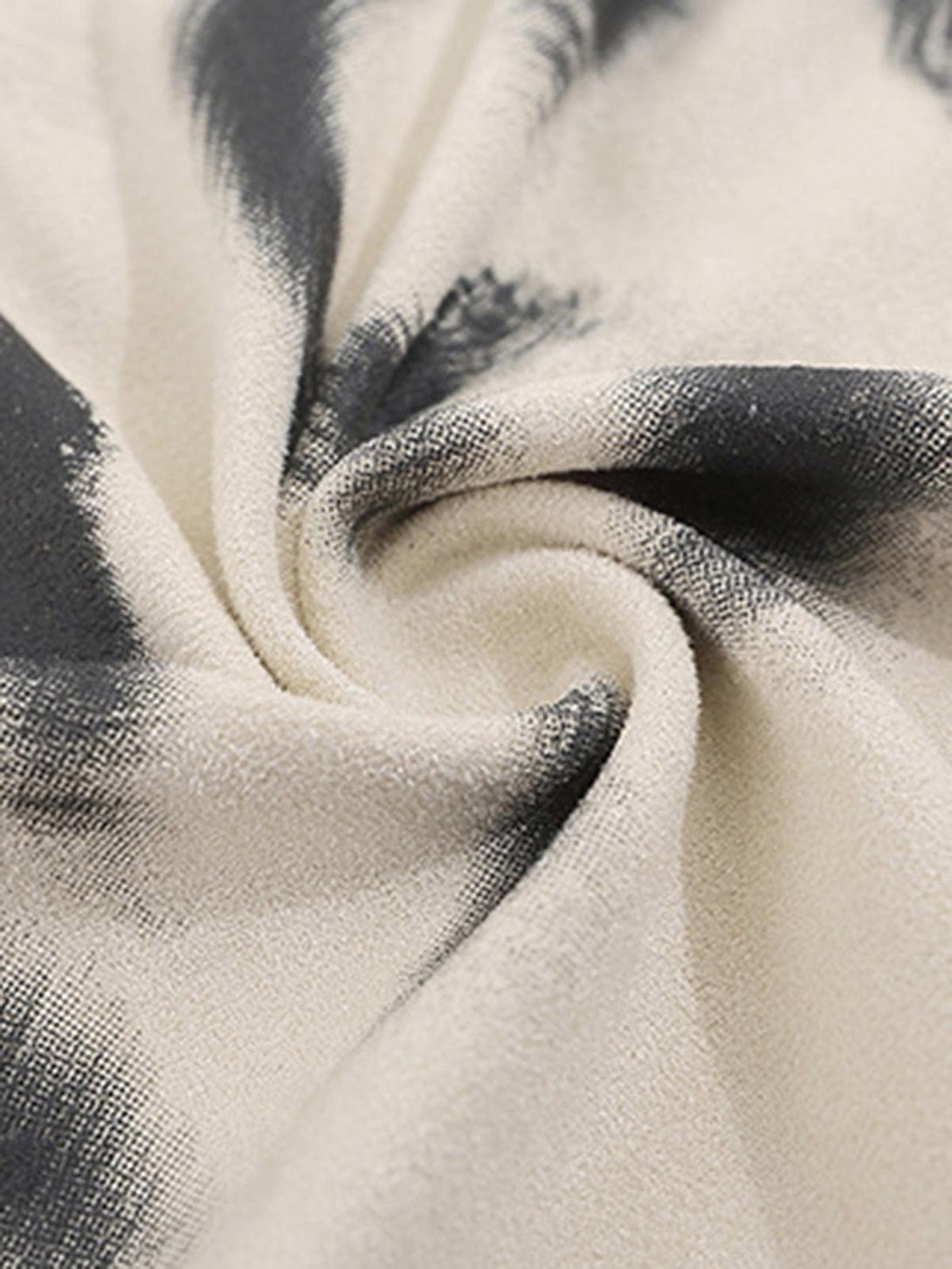 Intricate look at the abstract print on a beige vest, showcasing the unique design by TALISHKO.