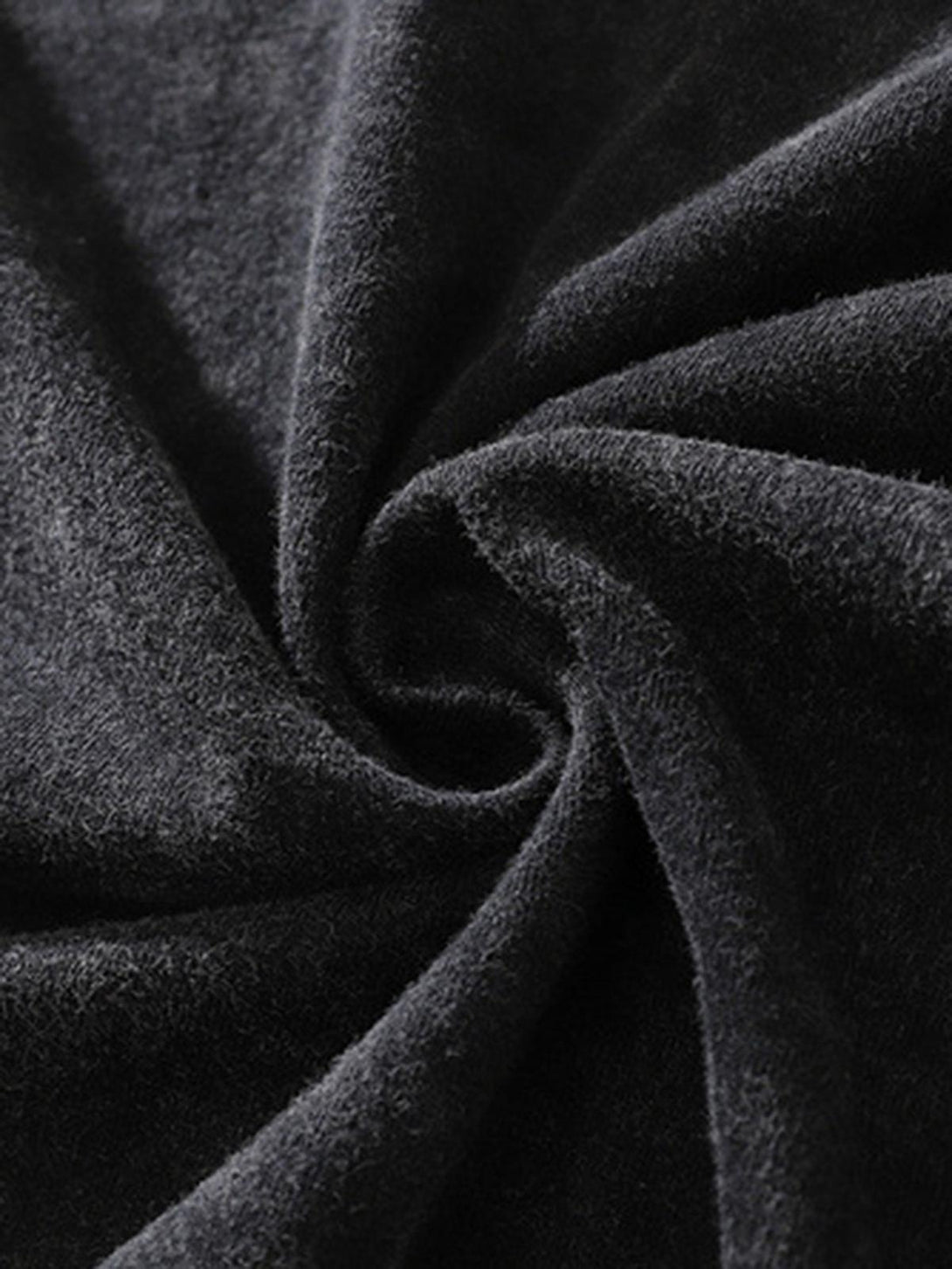 A tight crop highlighting TALISHKO's textured fabric, perfect for a retro hip-hop vibe.