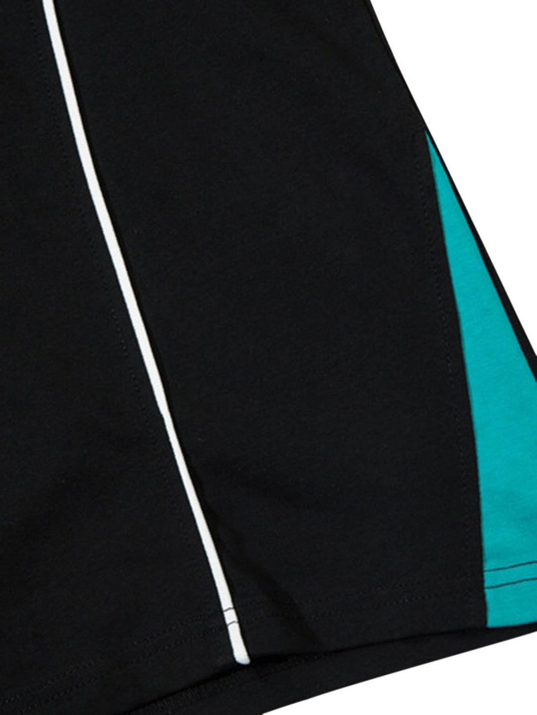 A detailed look at the black and teal paneling on a TALISHKO basketball T-shirt.