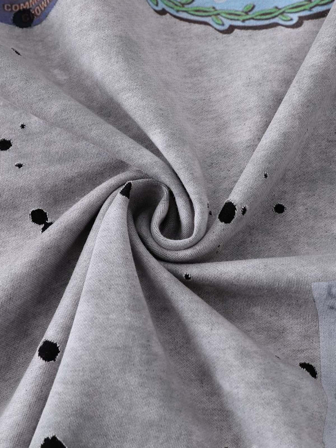 Zoomed-in texture of TALISHKO's retro ink splash T-shirt, highlighting artistic fabric details.