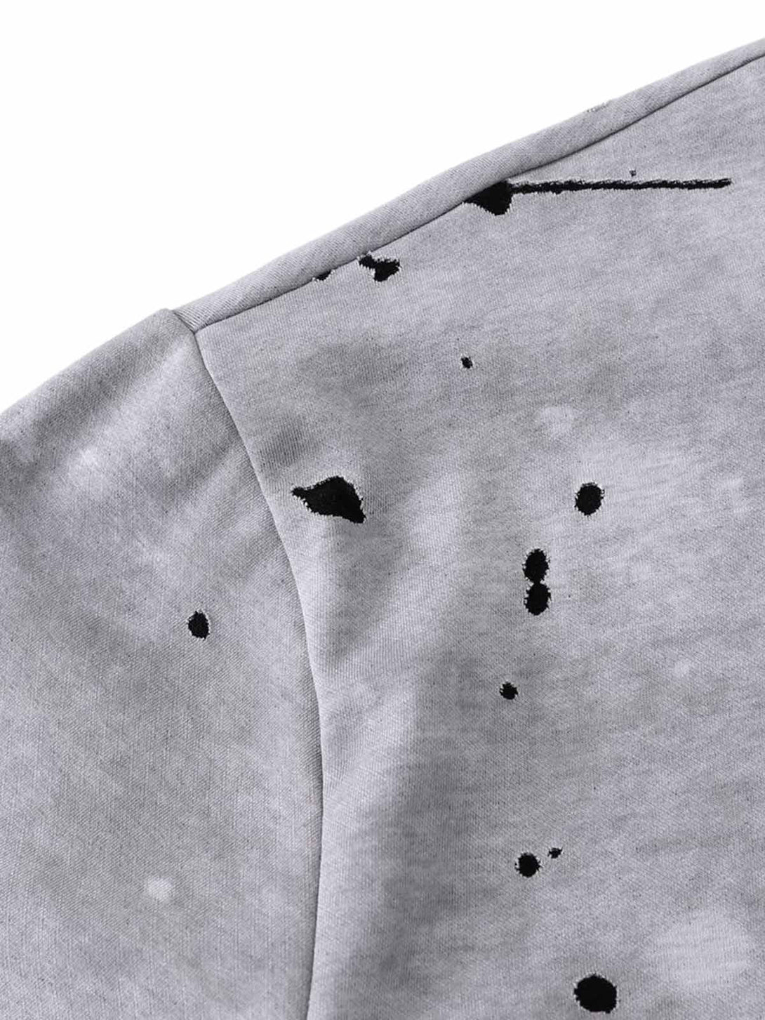 Detailed fabric of TALISHKO's gray T-shirt, showcasing ink splash design with artistic style.