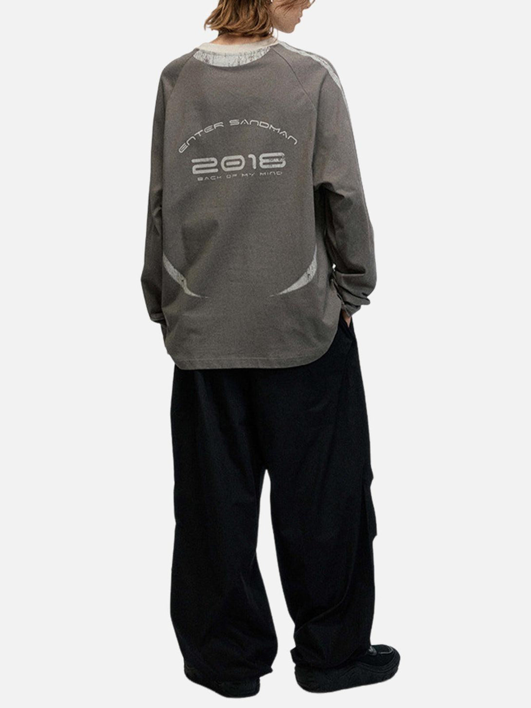 Back view of TALISHKO oversized long sleeves T-shirt with retro design, paired with loose pants.