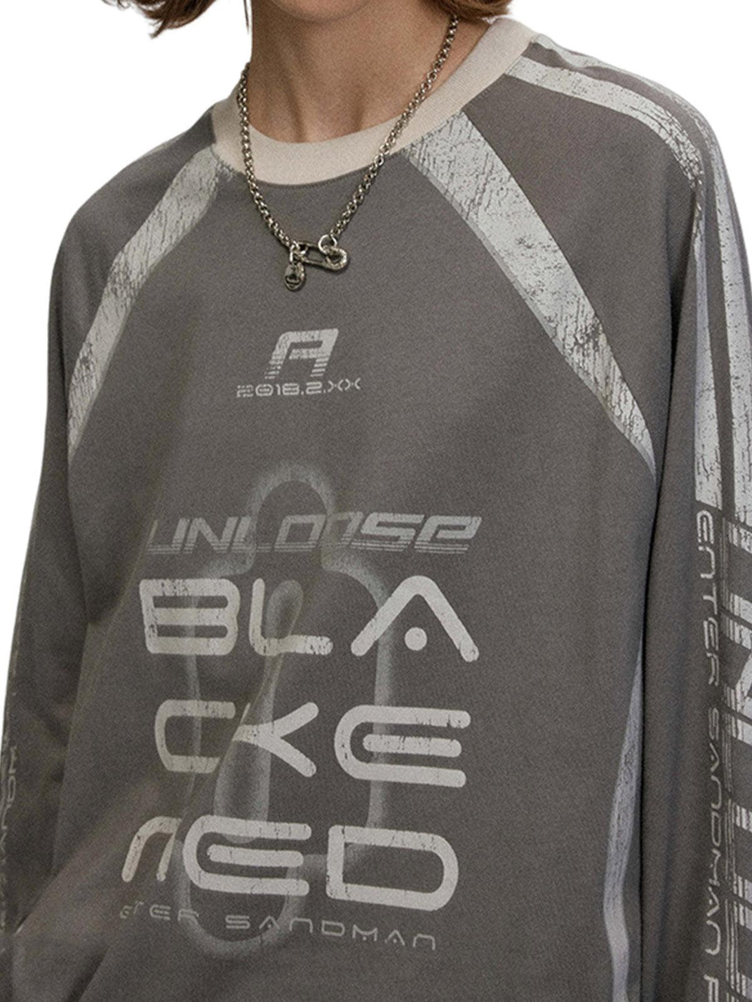 Model wearing a TALISHKO oversized T-shirt with retro graphics and a casual style.