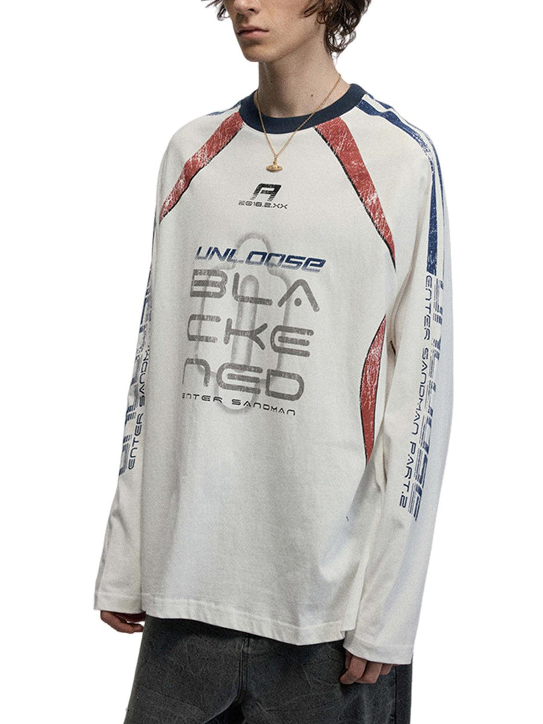 Model in TALISHKO oversized long-sleeve T-shirt with retro graphics and casual style.