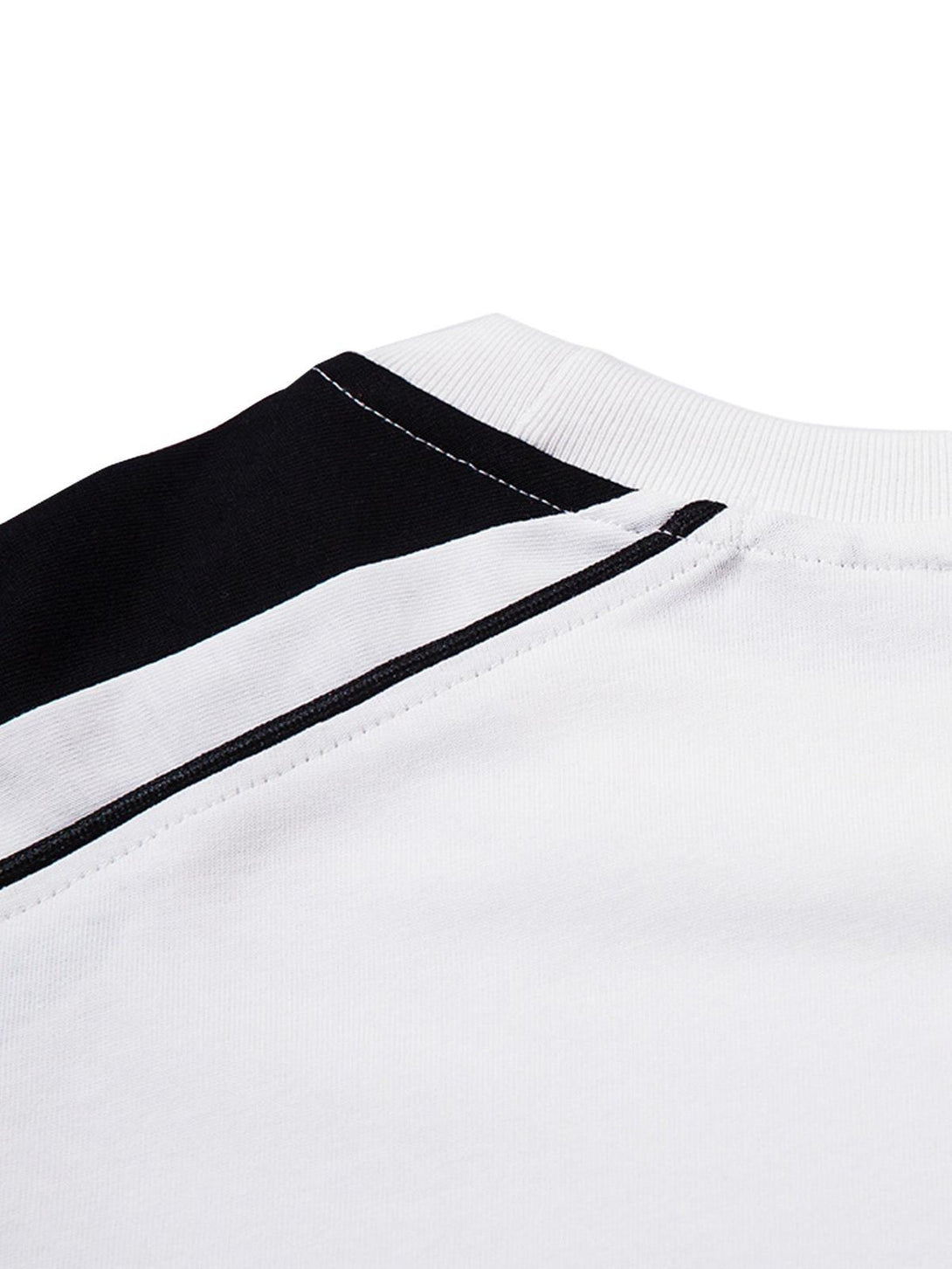 Intricate look at the TALISHKO retro jersey T-shirt's stitching, highlighting black and white contrast.