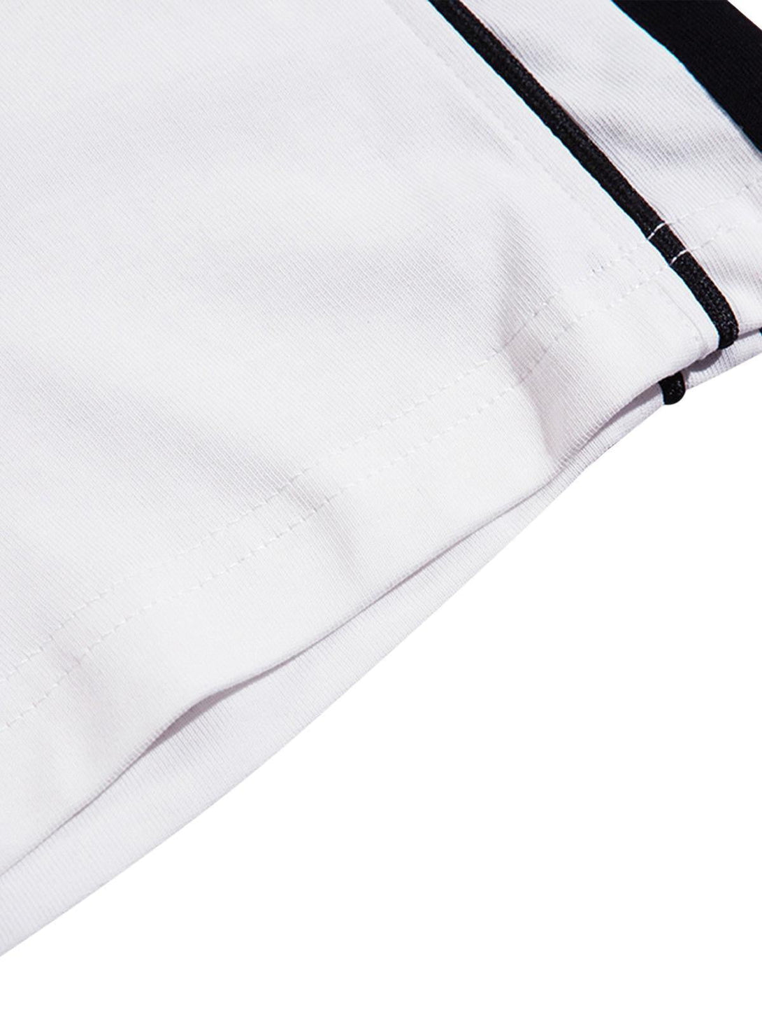 A detailed view of the TALISHKO retro jersey T-shirt, showcasing its crisp white fabric and black accents.