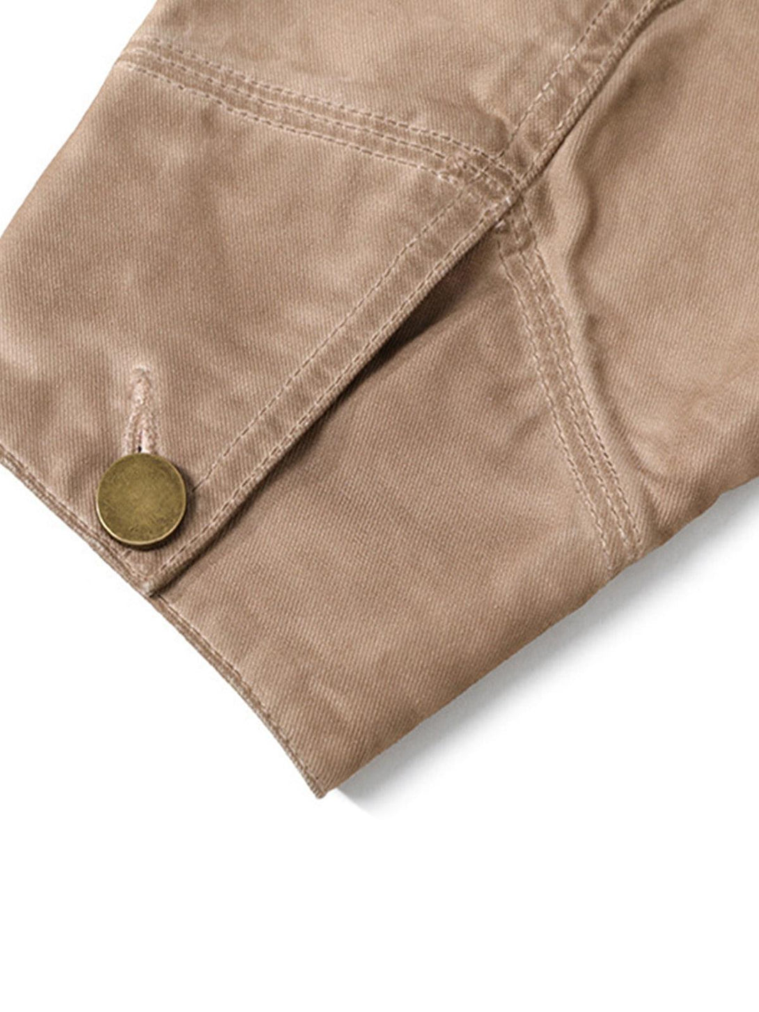 A detailed view of TALISHKO's retro work jacket sleeve, highlighting stitching and button detail.