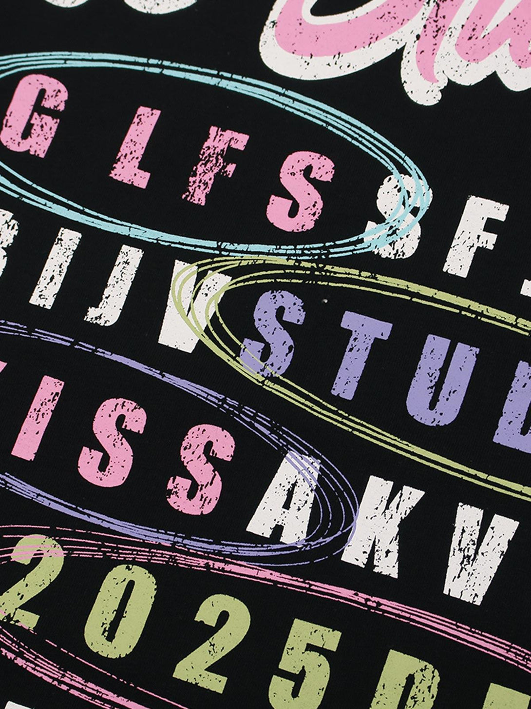Close-up of colorful retro letters on a black T-shirt by TALISHKO, showcasing vibrant style.