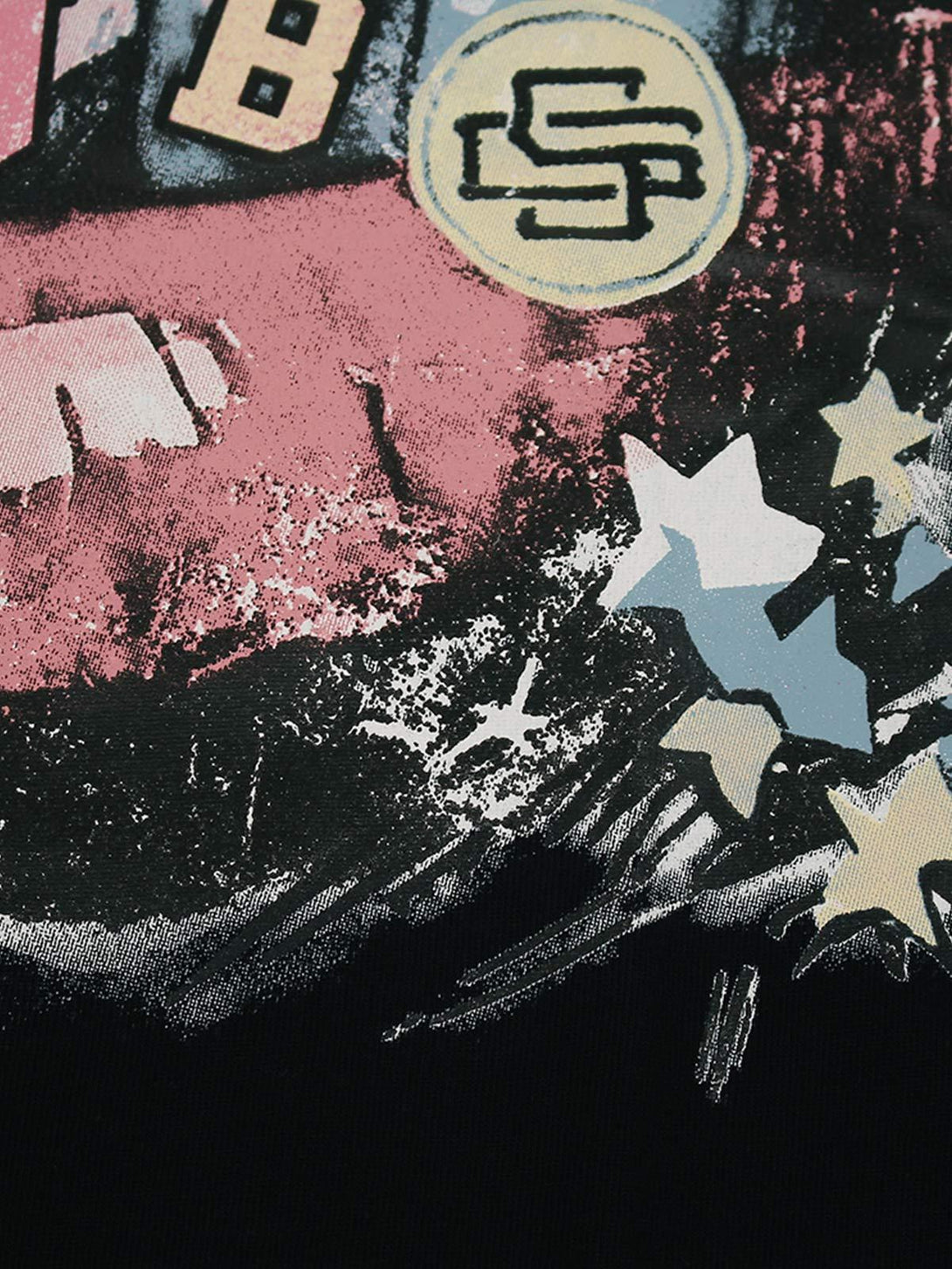 A detailed view of the retro letter and star design on the TALISHKO graphic T-shirt.
