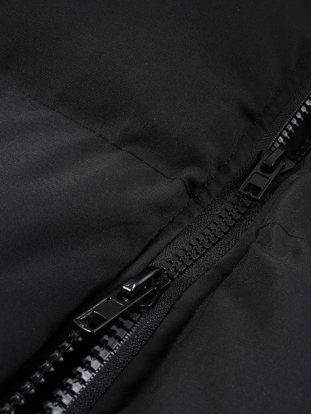 A detailed look at the zipper on the TALISHKO down jacket, showcasing its sleek design.