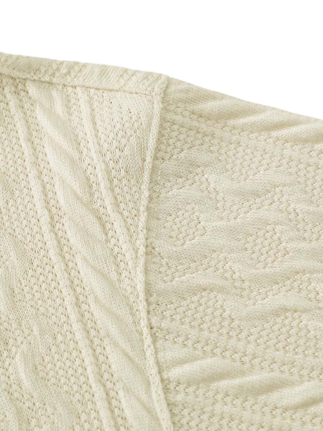 Intricate knit pattern detail on TALISHKO's retro polo shirt, emphasizing texture and design.