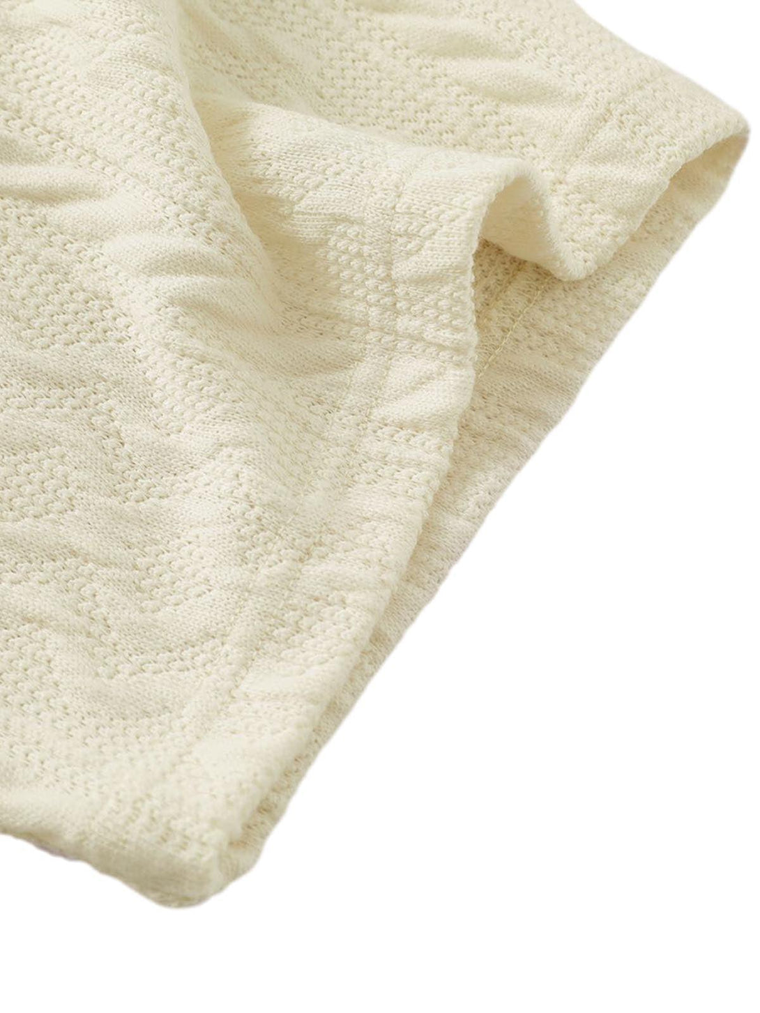 Intricate knit texture of TALISHKO's retro polo shirt, highlighting fabric detail and design.