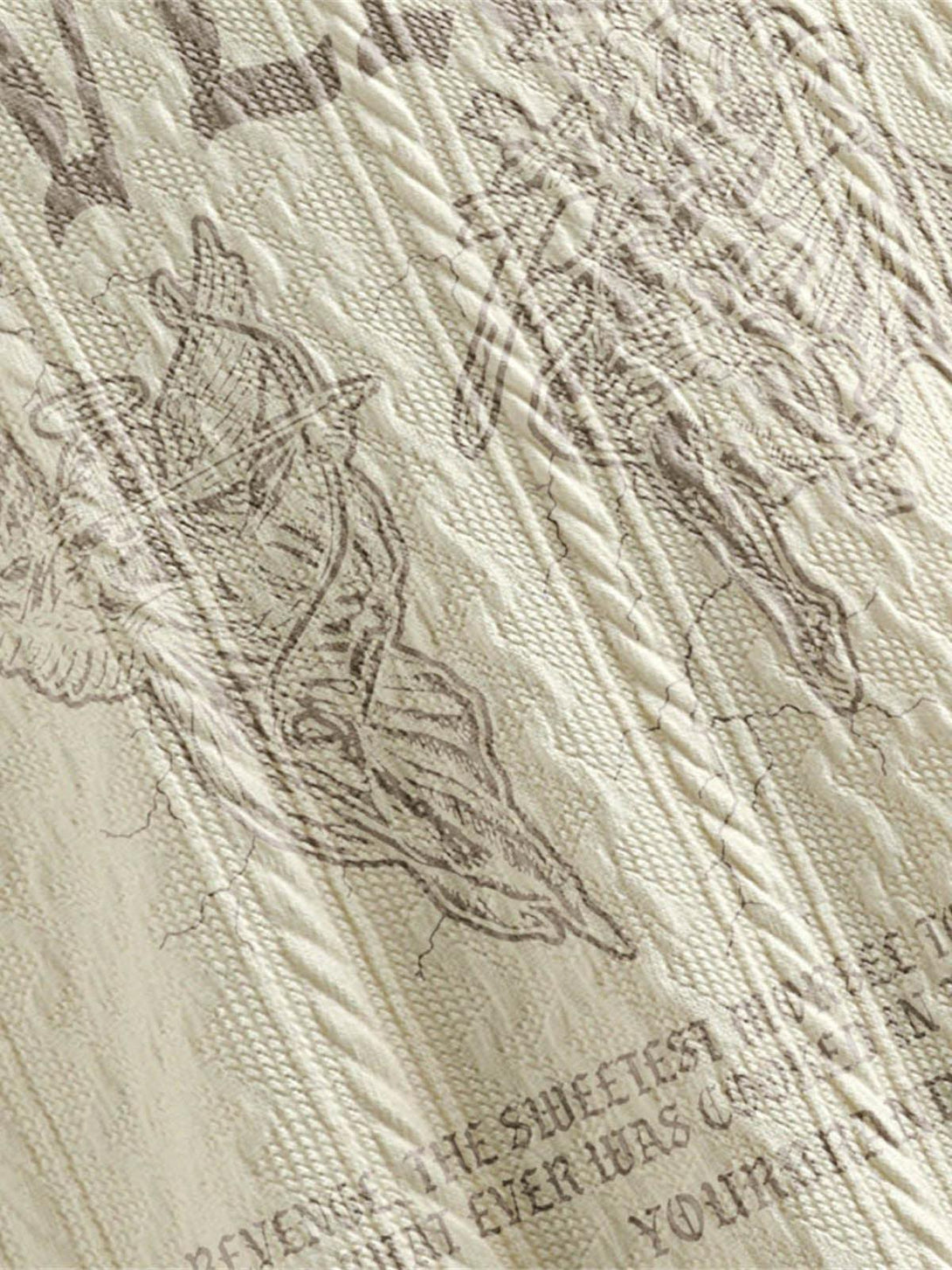 Intricate look at the letter print design on TALISHKO's retro polo shirt, showcasing texture.