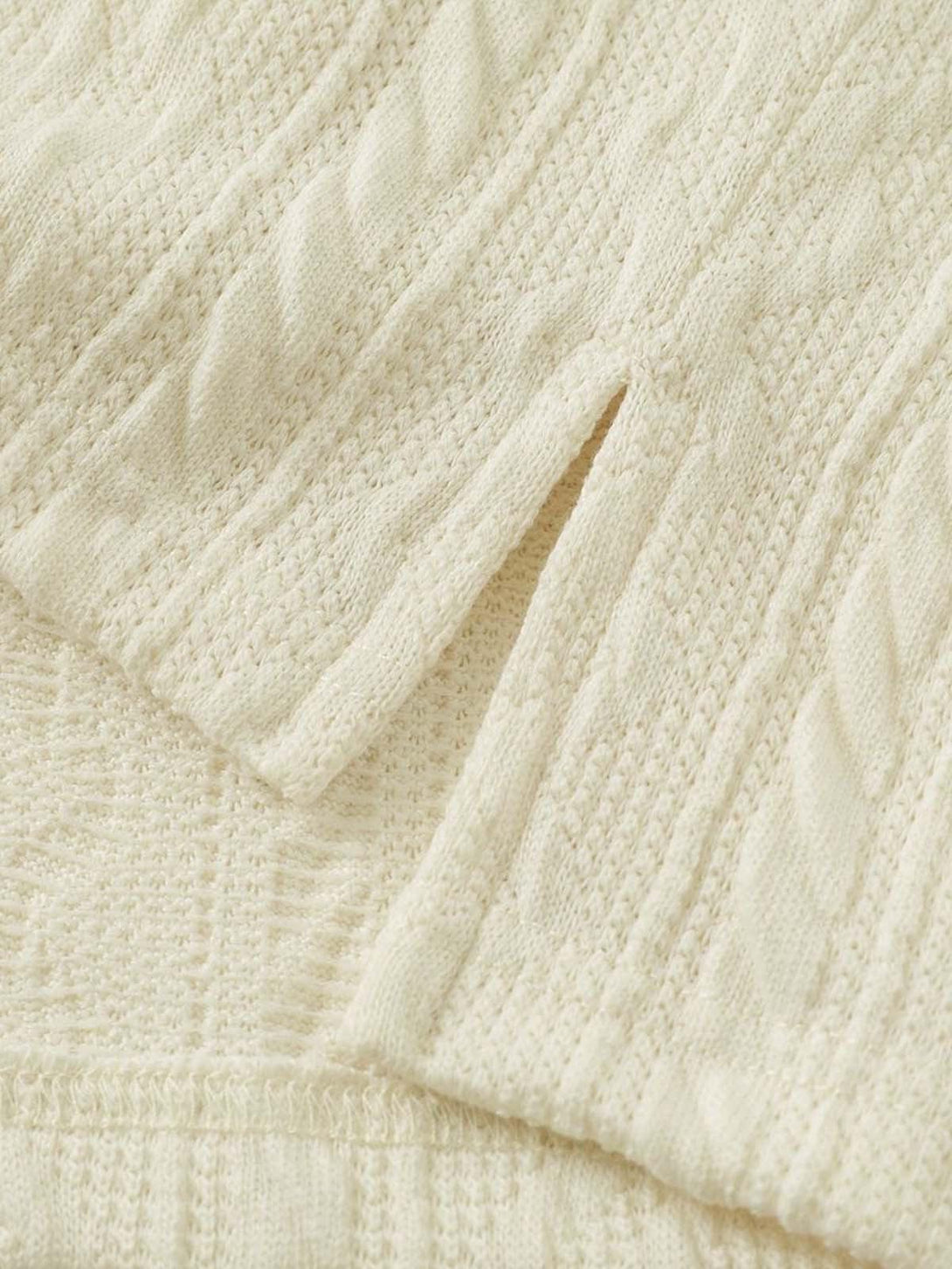 Detailed fabric and stitching on TALISHKO's retro polo shirt, highlighting cable knit texture.