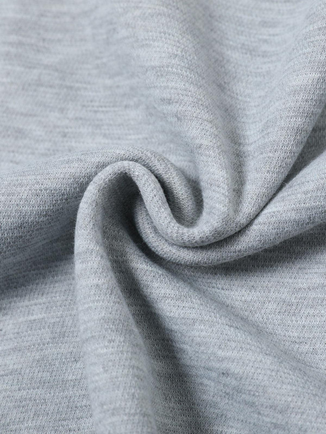 Zoomed-in texture of a gray T-shirt by TALISHKO, showcasing its soft and structured fabric.