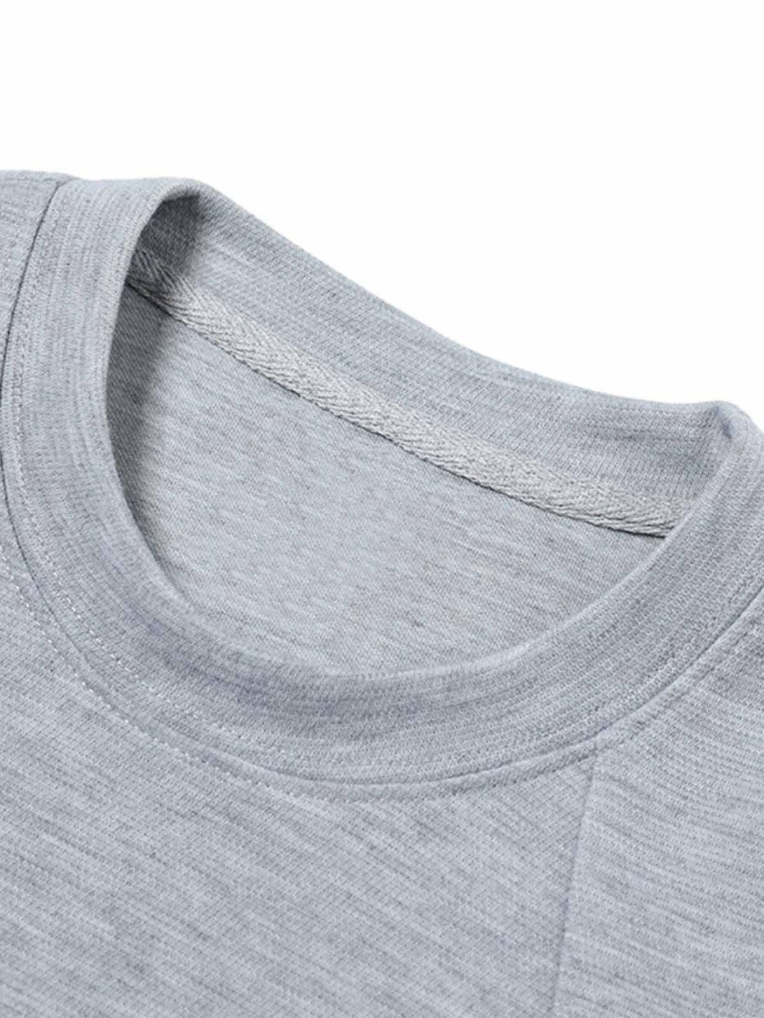 Detailed fabric and stitching of a gray T-shirt by TALISHKO, highlighting its cleanfit design.