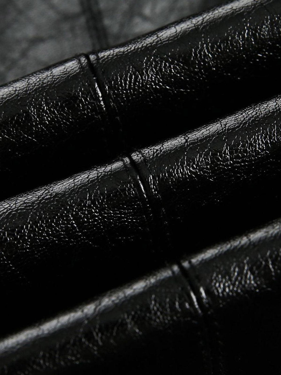 Texture and pattern showcased on TALISHKO's retro motorcycle PU leather jacket.