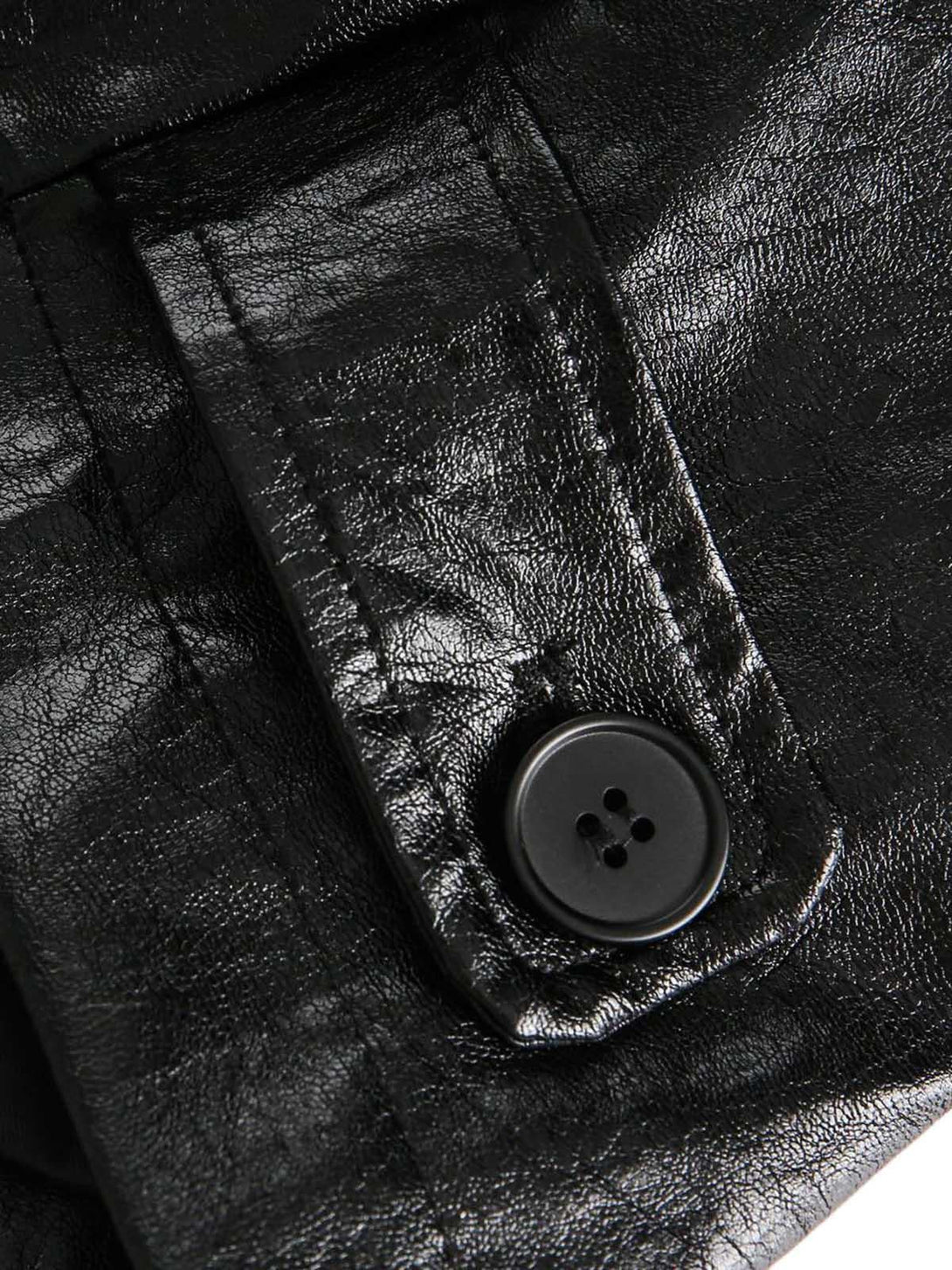 Focusing on the sleek button detail of TALISHKO's retro motorcycle PU leather jacket.