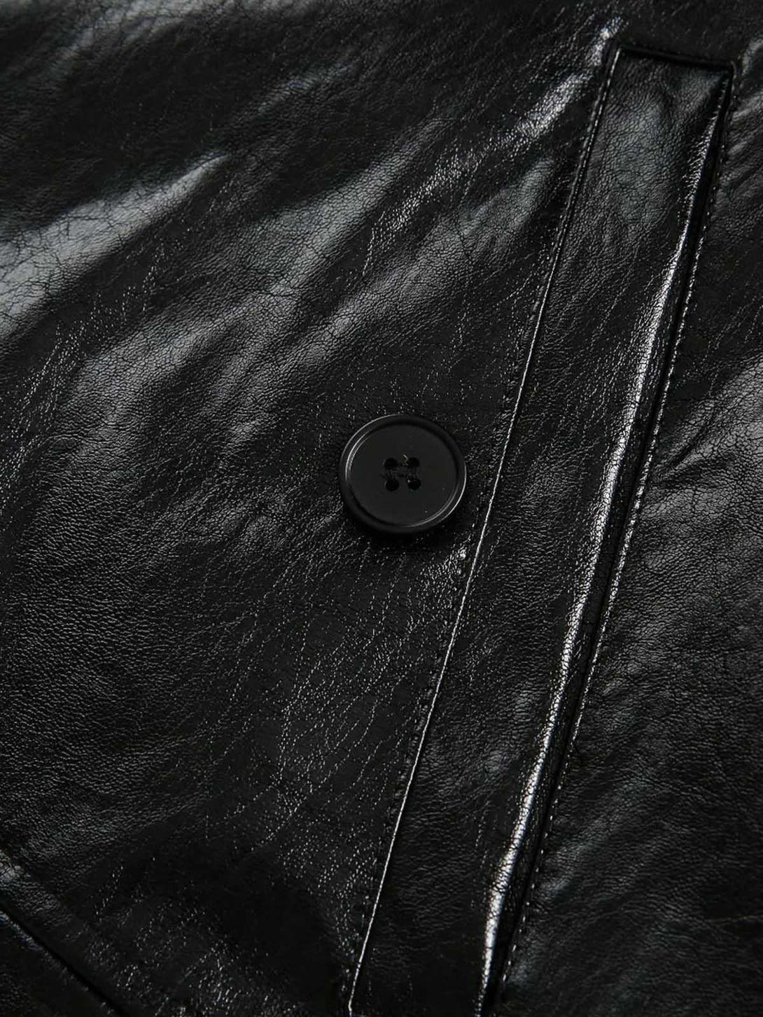 Detailed fabric and button design of TALISHKO's retro motorcycle PU leather jacket.