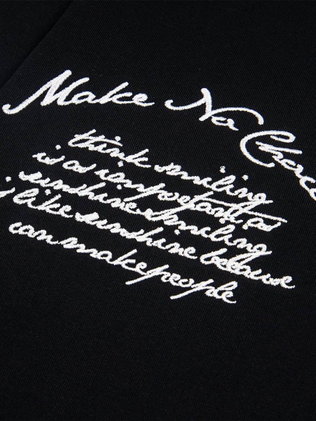 Intricate look at TALISHKO T-shirt embroidery, highlighting retro motorcycle-inspired script.