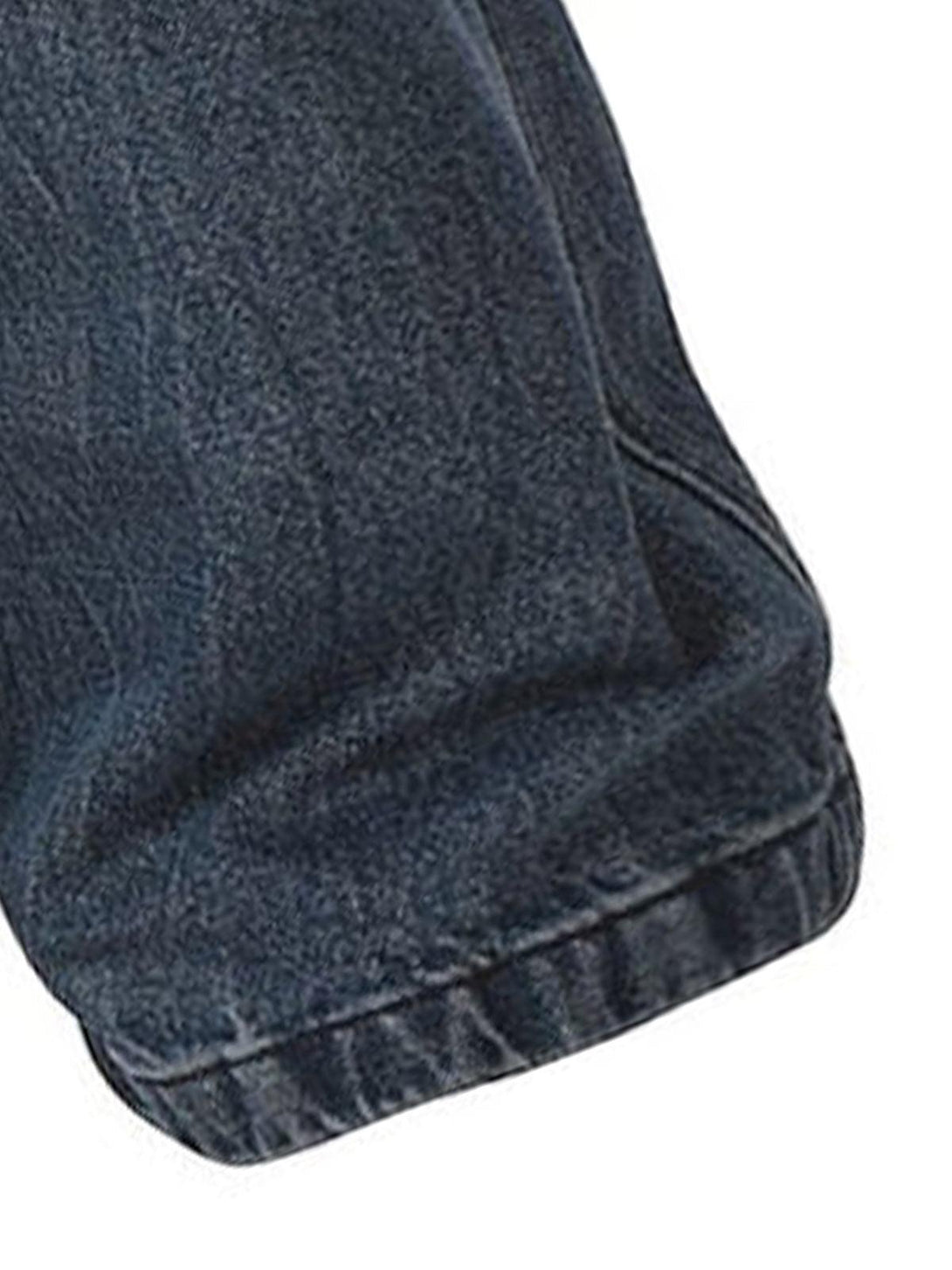 A close-up of TALISHKO retro washed jeans, showcasing detailed stitching and texture.