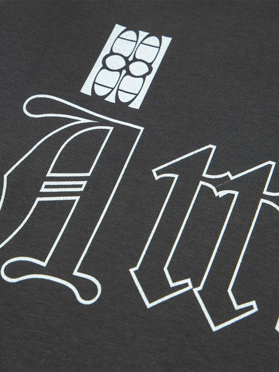 TALISHKO T-shirt detail highlighting bold retro lettering and intricate graphic design.