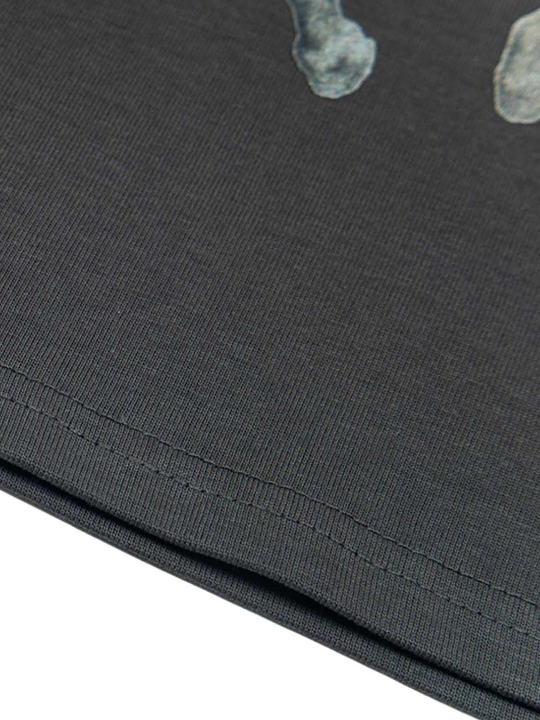 Intricate look at the stitching on a TALISHKO T-shirt, showcasing retro style details.