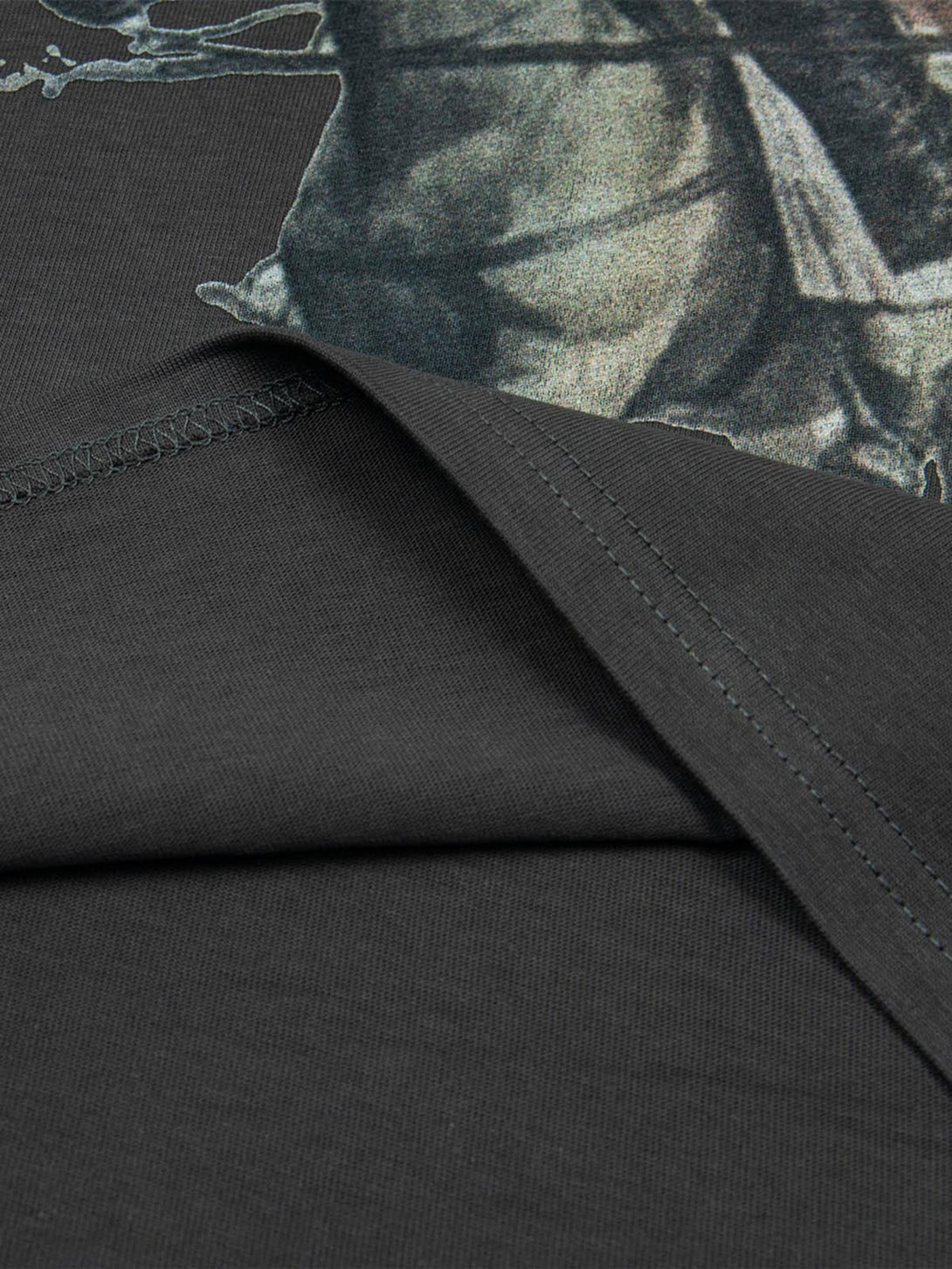 Detailed look at TALISHKO T-shirt fabric with retro oil painting print and precise stitching.