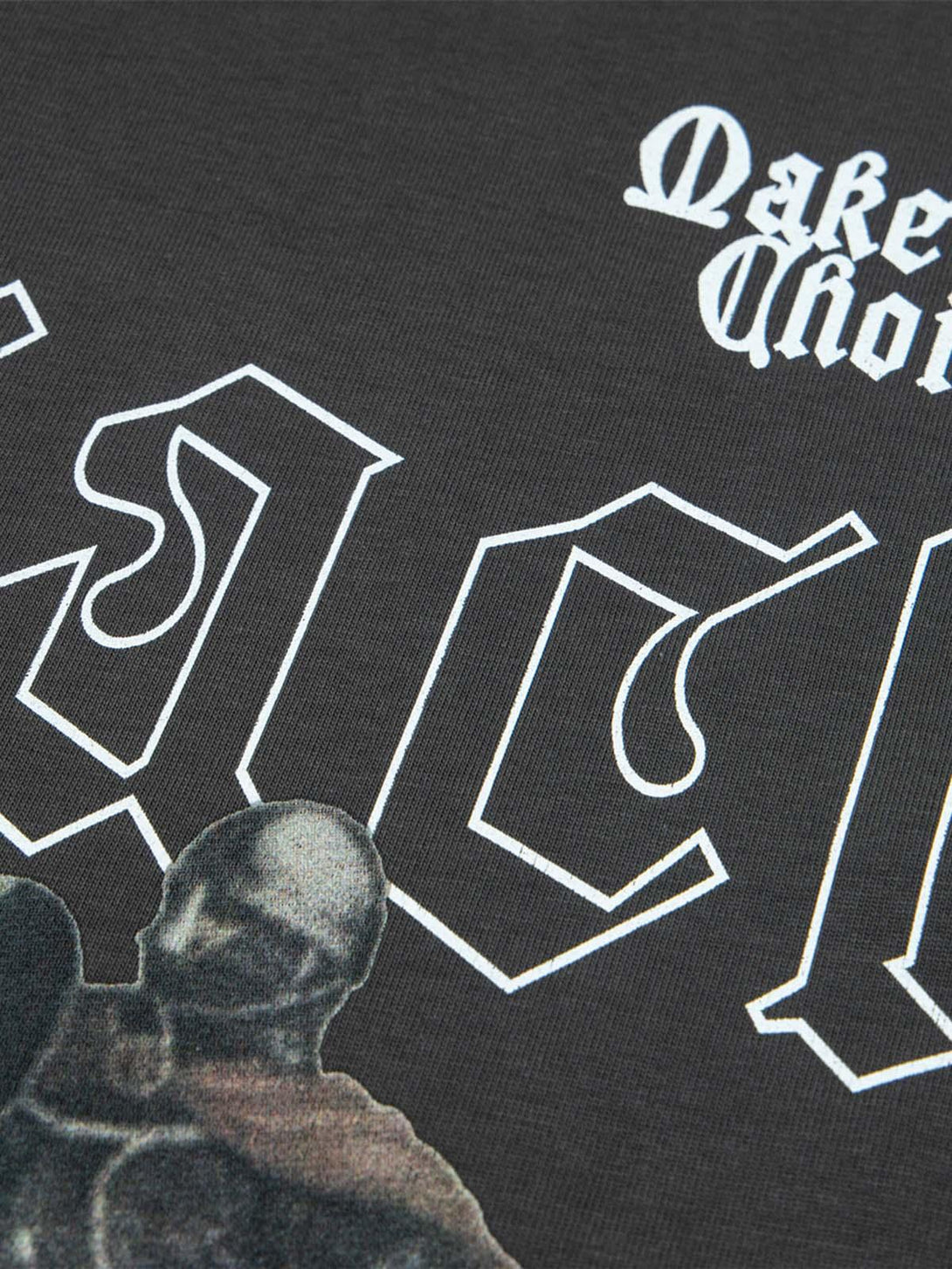 Zoomed-in texture of TALISHKO T-shirt features bold retro lettering and knight graphic design.