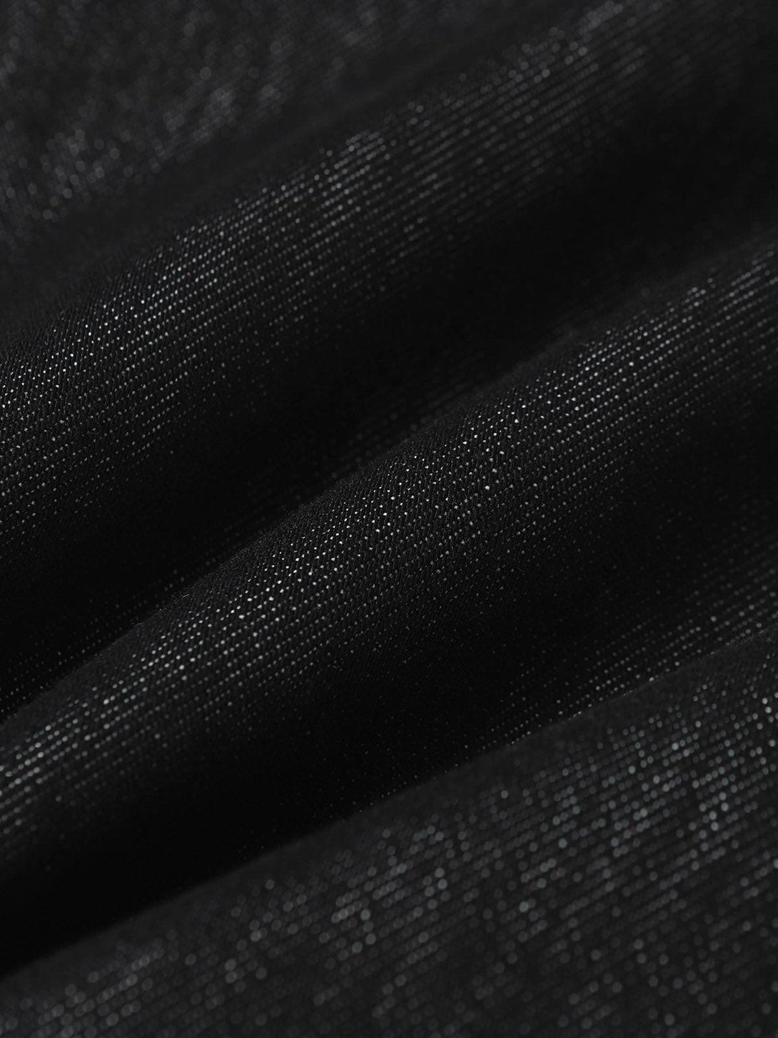 A tight crop highlighting the textured fabric of TALISHKO retro patchwork jeans.