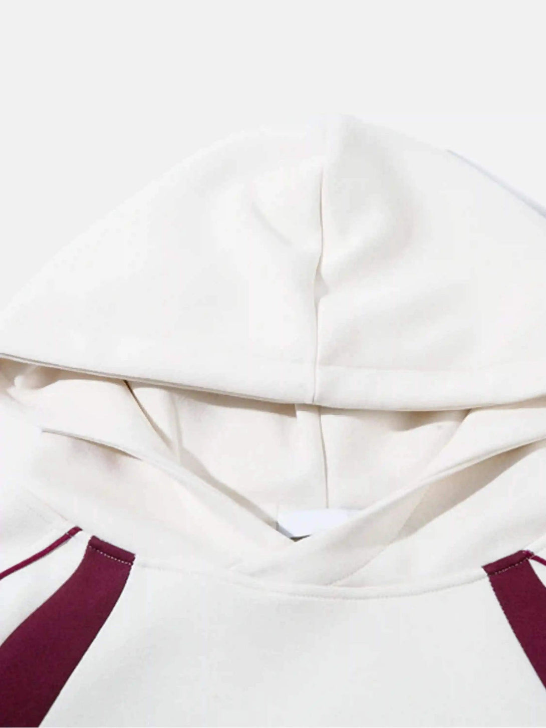 A detailed look at the TALISHKO hoodie, highlighting maroon accents and soft fabric texture.