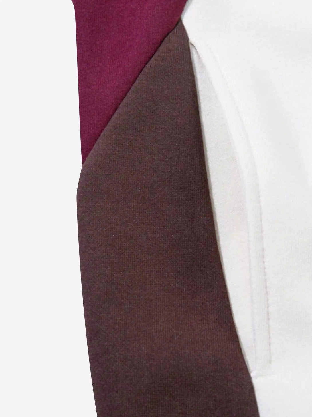 Tight crop highlighting TALISHKO hoodie’s retro patchwork and color contrast details.