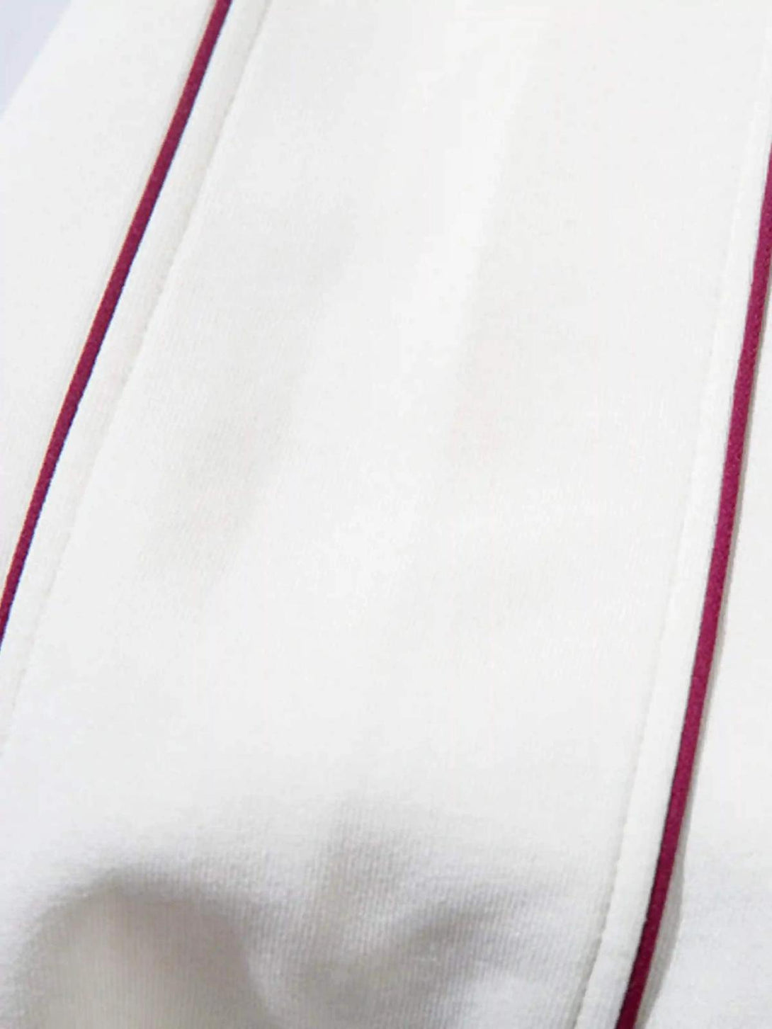 A tight crop highlighting the TALISHKO hoodie’s maroon accents and fabric texture.