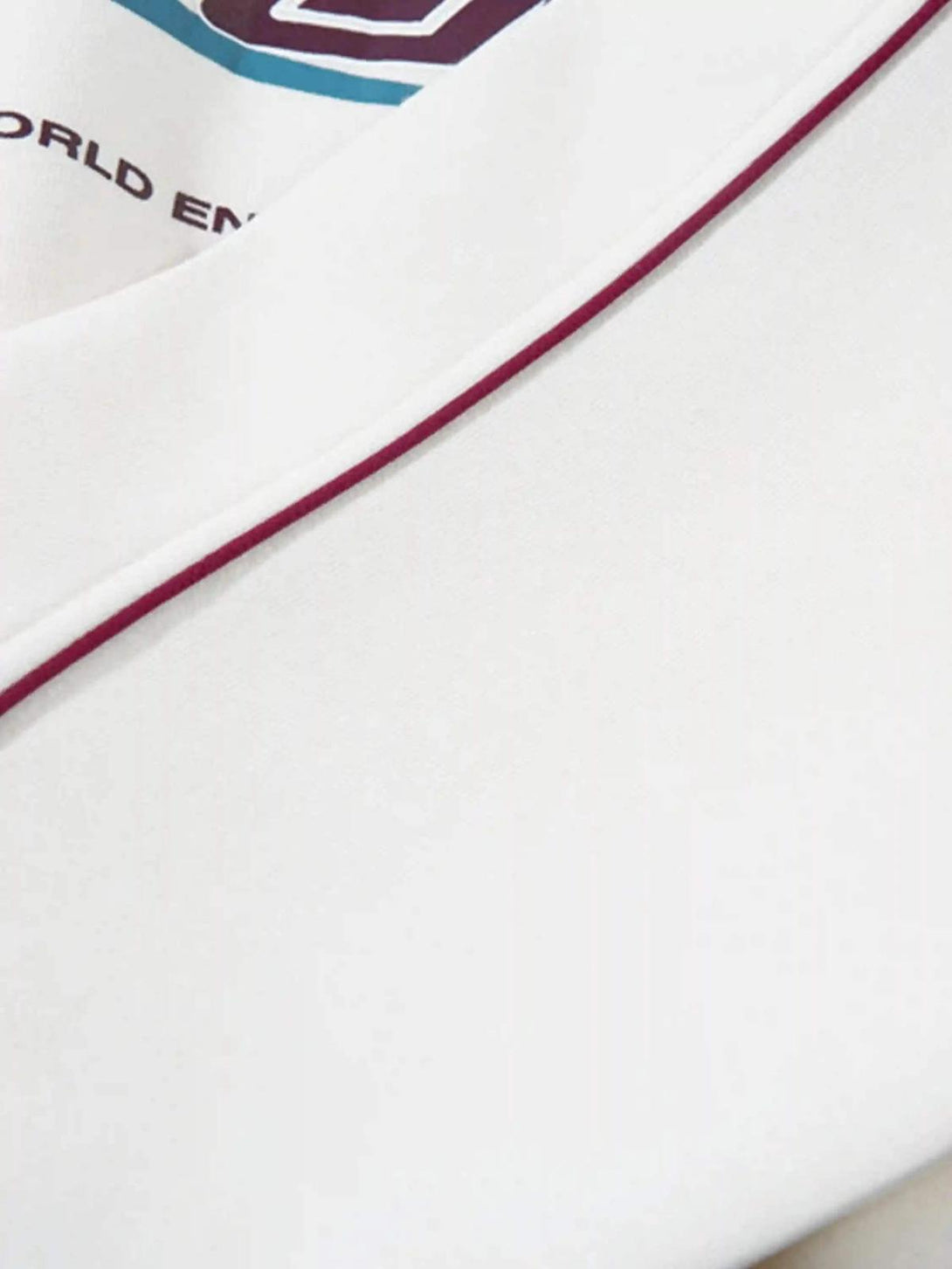 Detailed fabric and stitching on the TALISHKO hoodie, featuring maroon and retro patchwork.