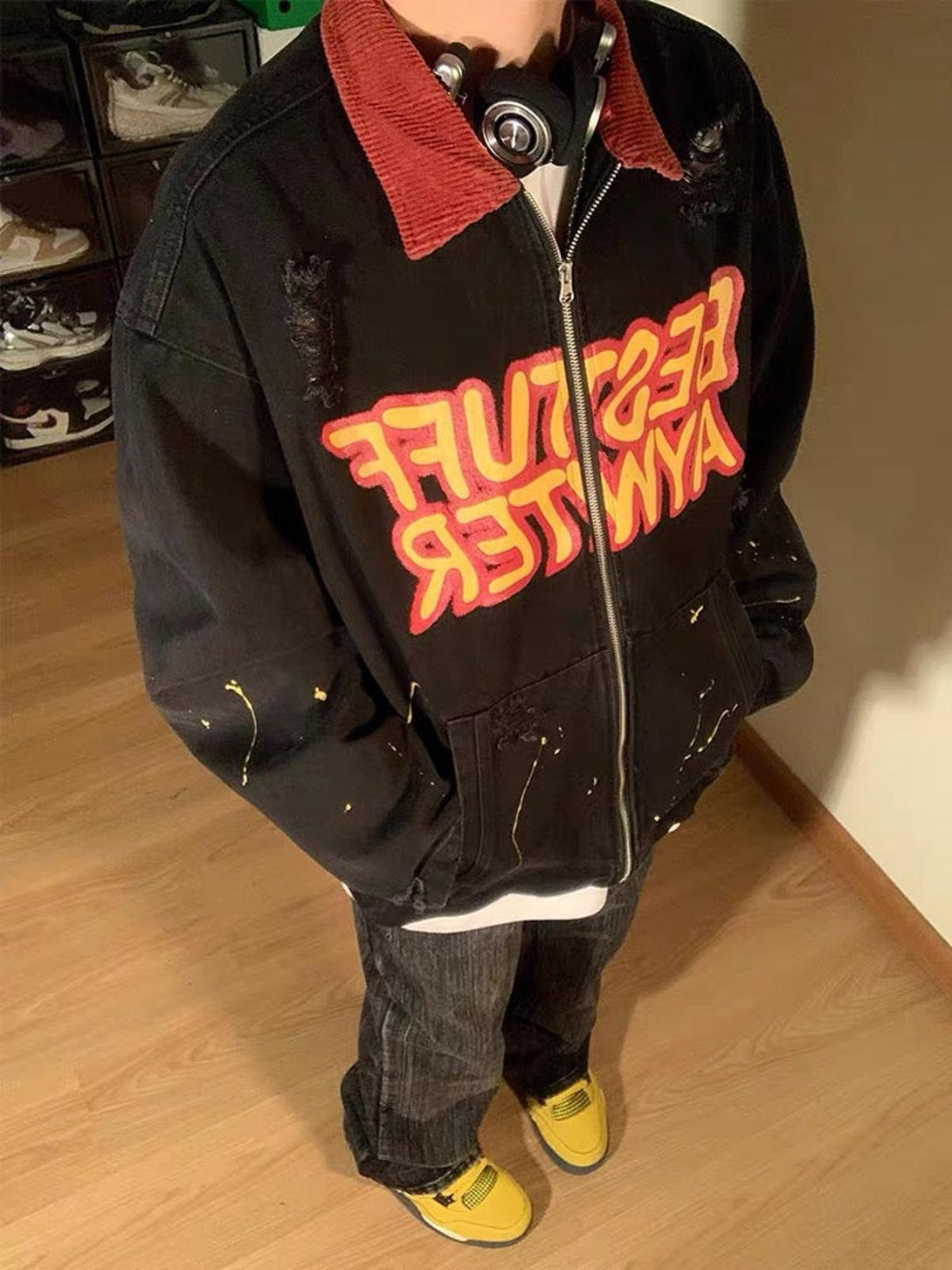 Model in a TALISHKO jacket with red collar and lettering, paired with yellow sneakers.