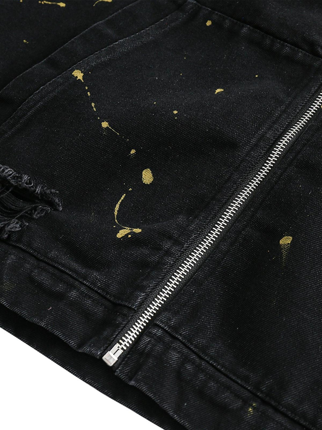 A detailed view of TALISHKO's denim jacket, showcasing unique paint splatter and zipper detail.