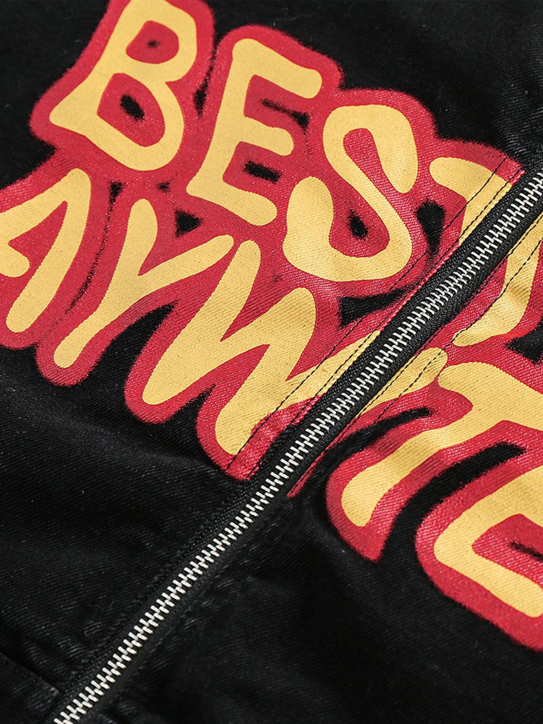 Intricate look at TALISHKO's retro denim jacket, highlighting bold yellow and red lettering.