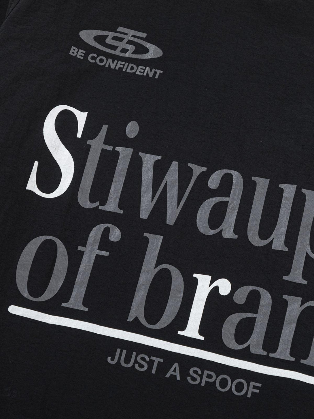 Quirky text detail on a TALISHKO retro patchwork long-sleeved T-shirt for a playful look.