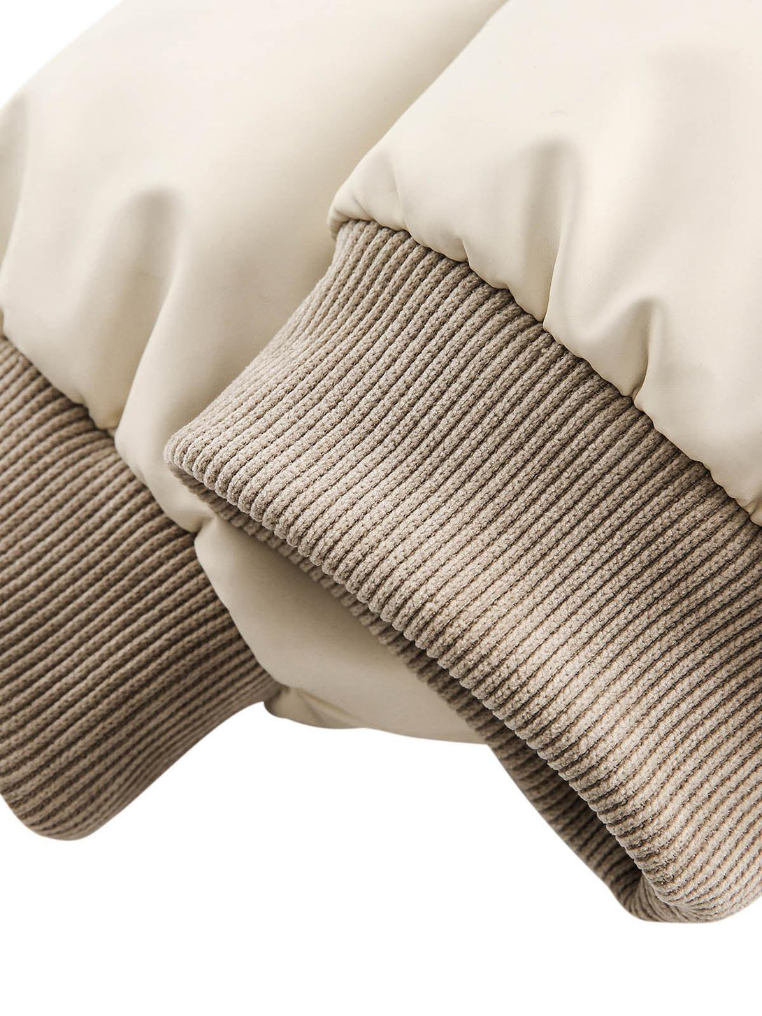 A close-up of TALISHKO's puffer bomber jacket, featuring ribbed cuffs and soft fabric texture.
