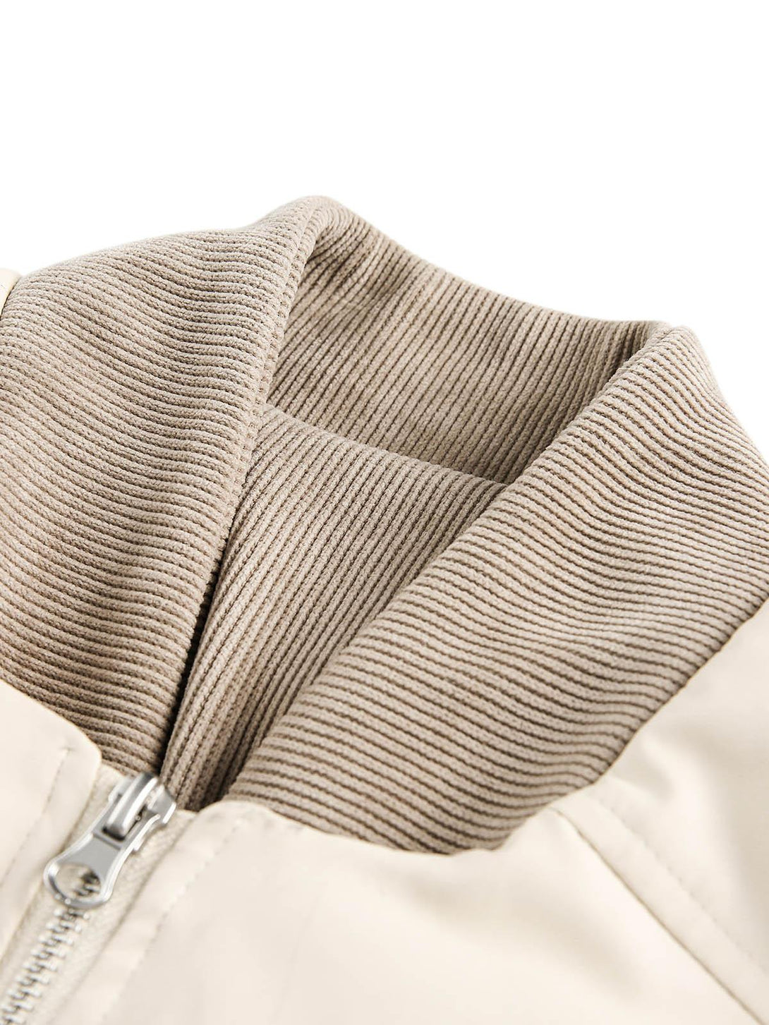 Intricate look at the ribbed collar detail of TALISHKO's puffer bomber jacket.